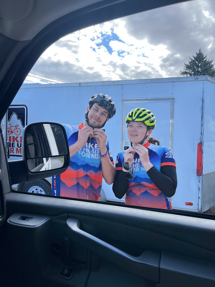 Photo of Charlotte buckling her helmet for Northern Tier